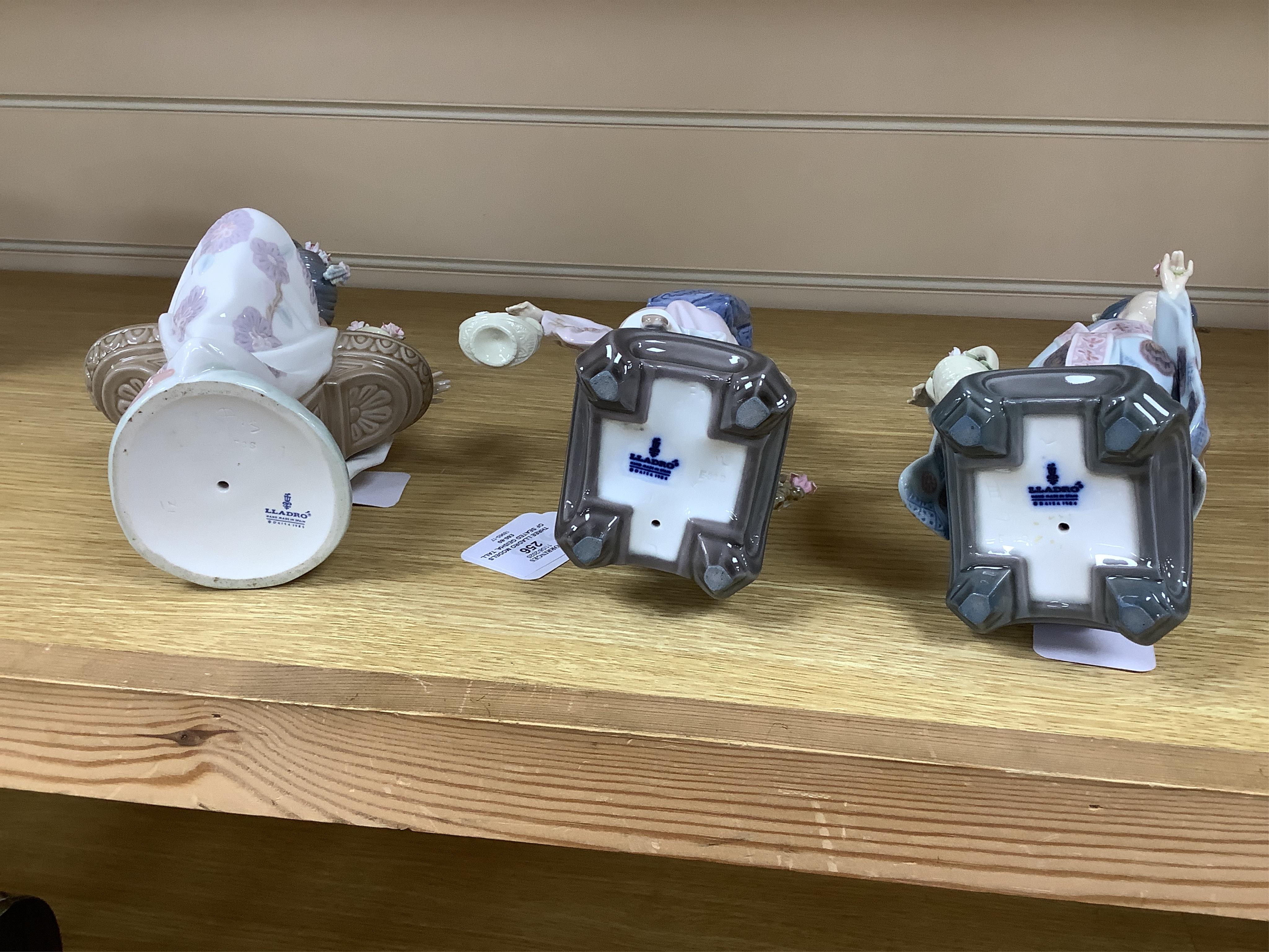 Three Lladro models of seated Geisha. Tallest 23cm